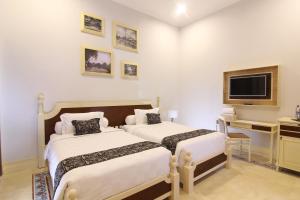 Cama o camas de una habitación en Java Villas Boutique Hotel & Resto