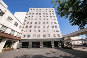 a tall white building with a lot of windows at Main Hotel - Vacation STAY 82546 in Miyakonojō