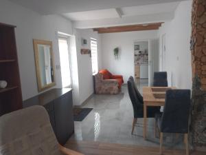a living room with a table and chairs at Noclegi Puńsk w centrum 50 m in Puńsk
