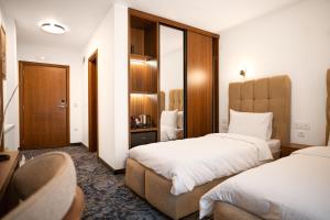 a hotel room with two beds and a mirror at Alexander Resort in Sopot +43 photos