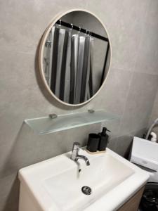 a bathroom with a sink and a mirror at Modern appartement nabij boulevard in Emmerich