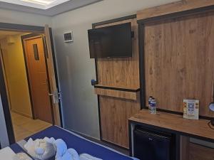 a room with a tv on a wall with a bed at Vizyon Hotel Center in Istanbul