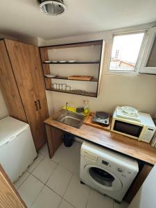 a small kitchen with a sink and a microwave at Vizyon Hotel Center in Istanbul +6 photos