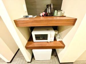 a microwave on a wooden shelf in a room at winco - Vacation STAY 06648v in Tokyo