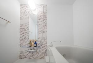 a white bathroom with a tub and a mirror at winco - Vacation STAY 06648v in Tokyo