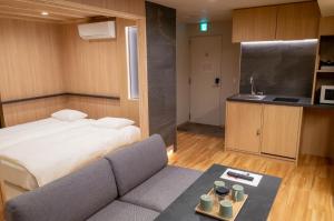 a room with a bed and a couch and a kitchen at winco - Vacation STAY 06660v in Tokyo