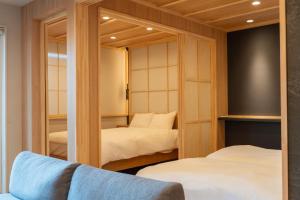 a small bedroom with two beds and a mirror at winco - Vacation STAY 06660v in Tokyo