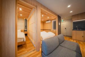 a room with a couch and a bed and a tv at winco - Vacation STAY 06660v in Tokyo