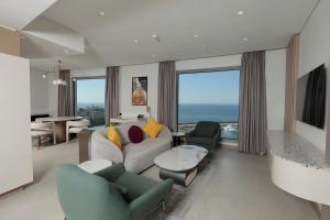 a living room with a couch and chairs at voco Beirut Central District by IHG in Beirut