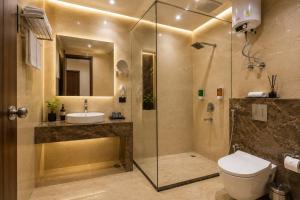a bathroom with a shower and a toilet and a sink at HOTEL ICONIC At Delhi International Airport in New Delhi