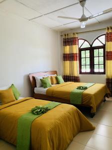 two beds sitting next to each other in a room at Royal Mount Hotel in Pussellawa