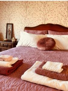 a bedroom with a bed with two towels on it at Vintage Boutique Room in Lavra