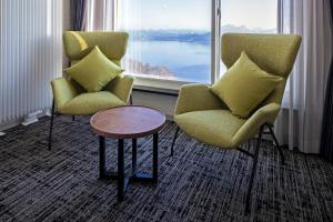 two chairs and a table in front of a window at Hotel Cocoa - Vacation STAY 29916v in Sakura