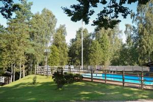 a wooden fence next to a swimming pool at Tallhöjden hotel & Restaurant in Simlångsdalen +43 photos