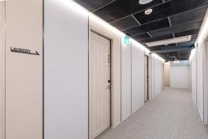 an empty corridor of an office building with a door at Heritage Collection on KG - Mobile App Check-In in Singapore