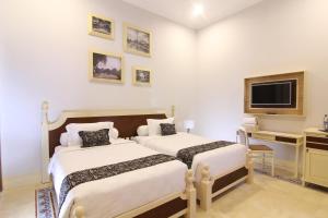 Cama o camas de una habitación en Java Villas Boutique Hotel & Resto