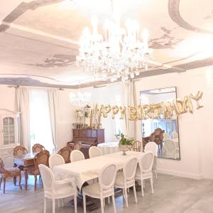 a dining room with a table with a happy birthday balloon at Casa Belgeri in Dongio