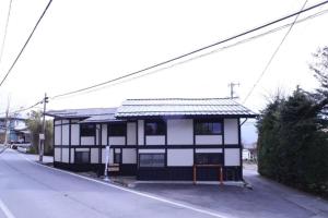 a black and white building on the side of a street at Cominka - Vacation STAY 30137v in Chino