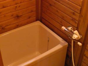 a bath tub in a bathroom with a wooden wall at Cottage Izu,com - Vacation STAY 07073v in Minamiizu +49 photos