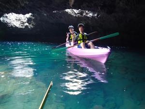 two people in a boat in the water near a cave at Cottage Izu,com - Vacation STAY 07073v in Minamiizu