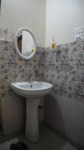 a bathroom with a sink and a mirror at Nilachal Homes in Guwahati
