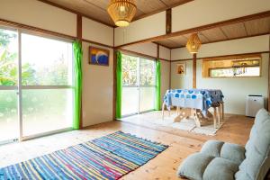 a living room with a table and some windows at Hide A Way - Vacation STAY 90104v in Nishinoomote +32 photos