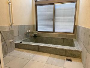 a bath tub in a bathroom with a window at Lavender - Vacation STAY 26426v in Nishina +8 photos