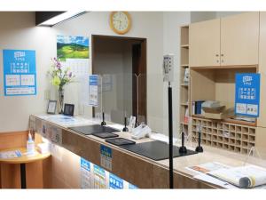 a room with a counter with a clock on the wall at Anan Station Hotel - Vacation STAY 11048v in Anan