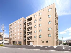 a large brick building on the side of a street at Anan Station Hotel - Vacation STAY 11048v in Anan