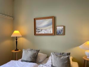 a bedroom with a bed and a picture on the wall at Roholtegaard in Faxe +31 photos