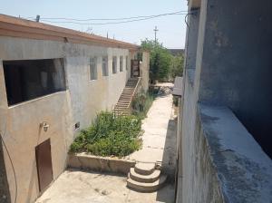 an empty alley with a building and a stairway at Esco Hostel in Nardaran