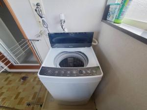 a washing machine with a blue seat in a bathroom at Corp Temma - Vacation STAY 08268v in Takayama