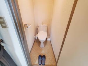 a bathroom with a toilet and a pair of shoes at Corp Temma - Vacation STAY 08268v in Takayama +6 photos