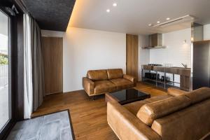 a living room with a couch and a table at Hotel Dios - Vacation STAY 31239v in Awaji