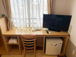 a desk with a computer on it with a window at Hotel Yamadaso - Vacation STAY 10193v in Nago +3 photos