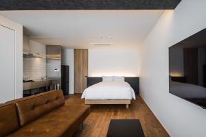 a bedroom with a bed and a couch at Hotel Dios - Vacation STAY 31424v in Awaji