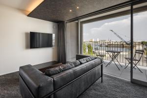 a living room with a couch and a large window at Hotel Dios - Vacation STAY 40406v in Awaji