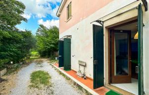 a building with green doors and a dirt road at Rasara in Arquà Petrarca +14 photos