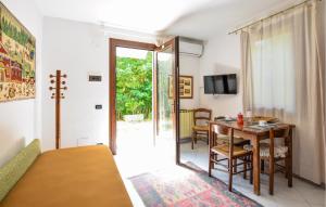 a bedroom with a table and a room with a dining room at Rasara in Arquà Petrarca