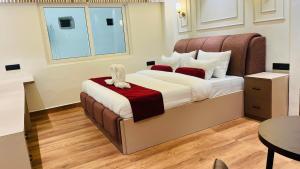 a bedroom with a bed with a stuffed animal on it at Aabuu Babuu Resort & Banquet in Kurseong