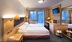 Postel nebo postele na pokoji v ubytování Hotel La Perla