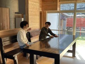 two men standing around a large table in a room at IHOKI BASE - Vacation STAY 57543v in Kumano