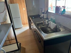 a kitchen with a sink and a refrigerator at IHOKI BASE - Vacation STAY 57543v in Kumano +10 photos