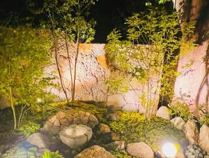 a garden with a pond and rocks and trees at CONNECT, - Vacation STAY 33451v in Arita