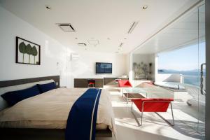 a bedroom with a large bed and a living room at Hotel Mare - Vacation STAY 24956v in Kure