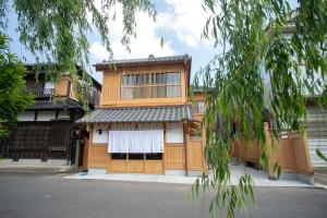 a building with a gate with a white curtain at Nagi - Vacation STAY 55367v in Katori +5 photos