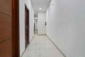 an empty hallway with white walls and a door at Super Collection O by OYO Patiala Road Crossway Zirakpur Formerly Lavish in Zirakpur