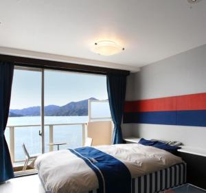 a bedroom with a bed and a view of the water at Hotel Mare - Vacation STAY 58102v in Kure