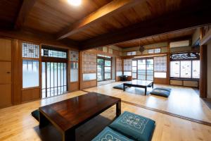 a living room with a table and some windows at Setouchi base - Vacation STAY 47136v in Mitoyo +5 photos