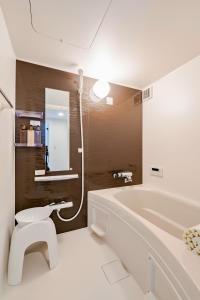 a bathroom with a tub and a toilet and a sink at Class Besso Ise - Vacation STAY 15745v in Iseji
